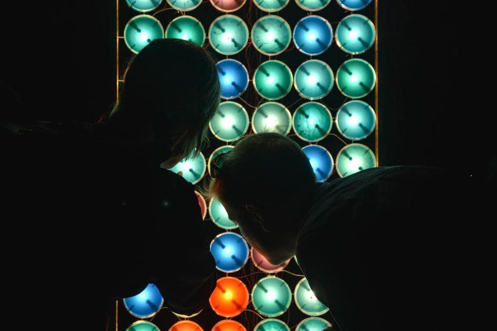 Two person checking an LED screen display