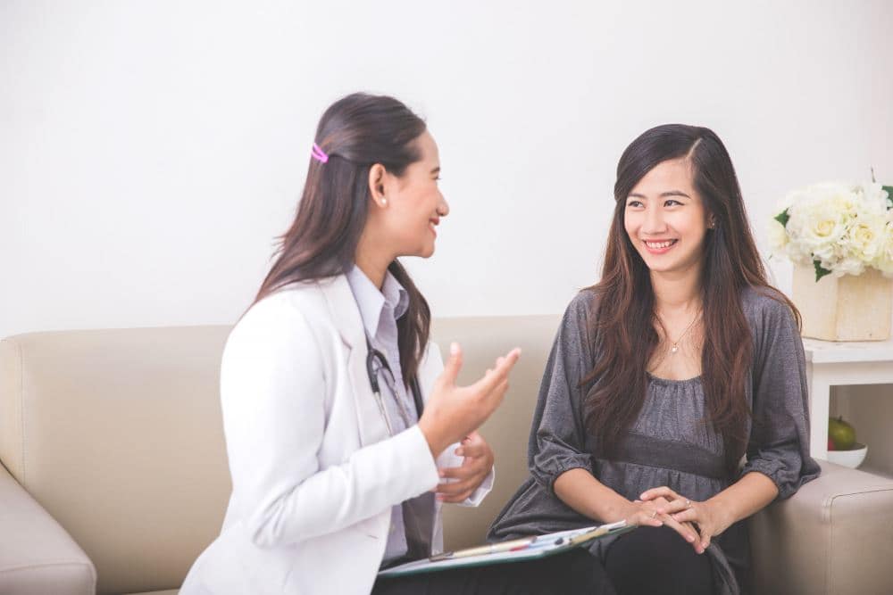 A female gynaecologist is treating a patient for menopause. (illustration)
