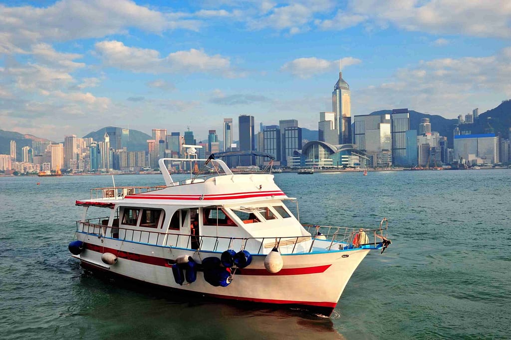 White ferry boat docked at a pier, ready to load passengers.